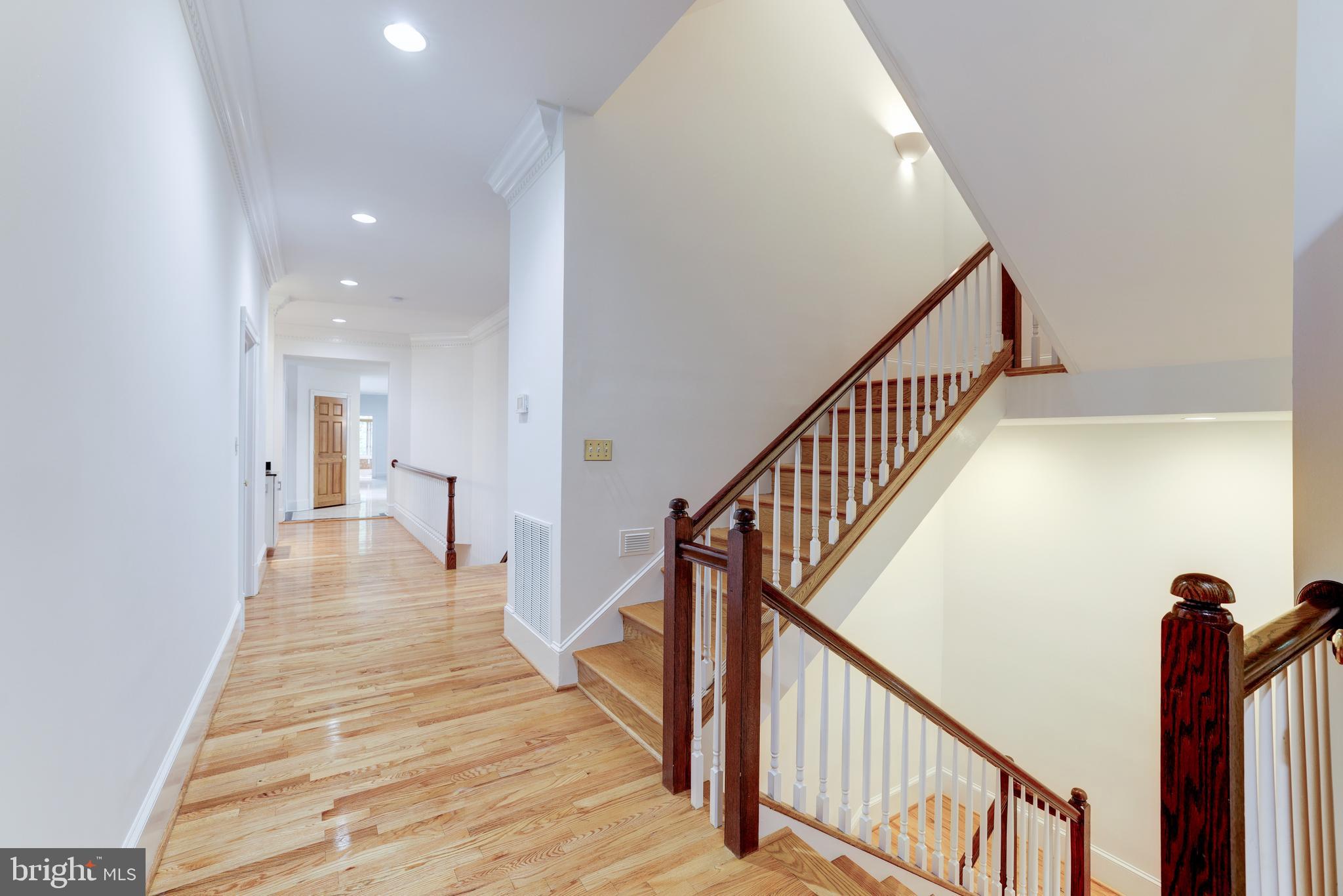 6832 Georgetown Pike McLean, VA 22101 - Photo 11 of 25 a view of a hallway with wooden floor and stairs