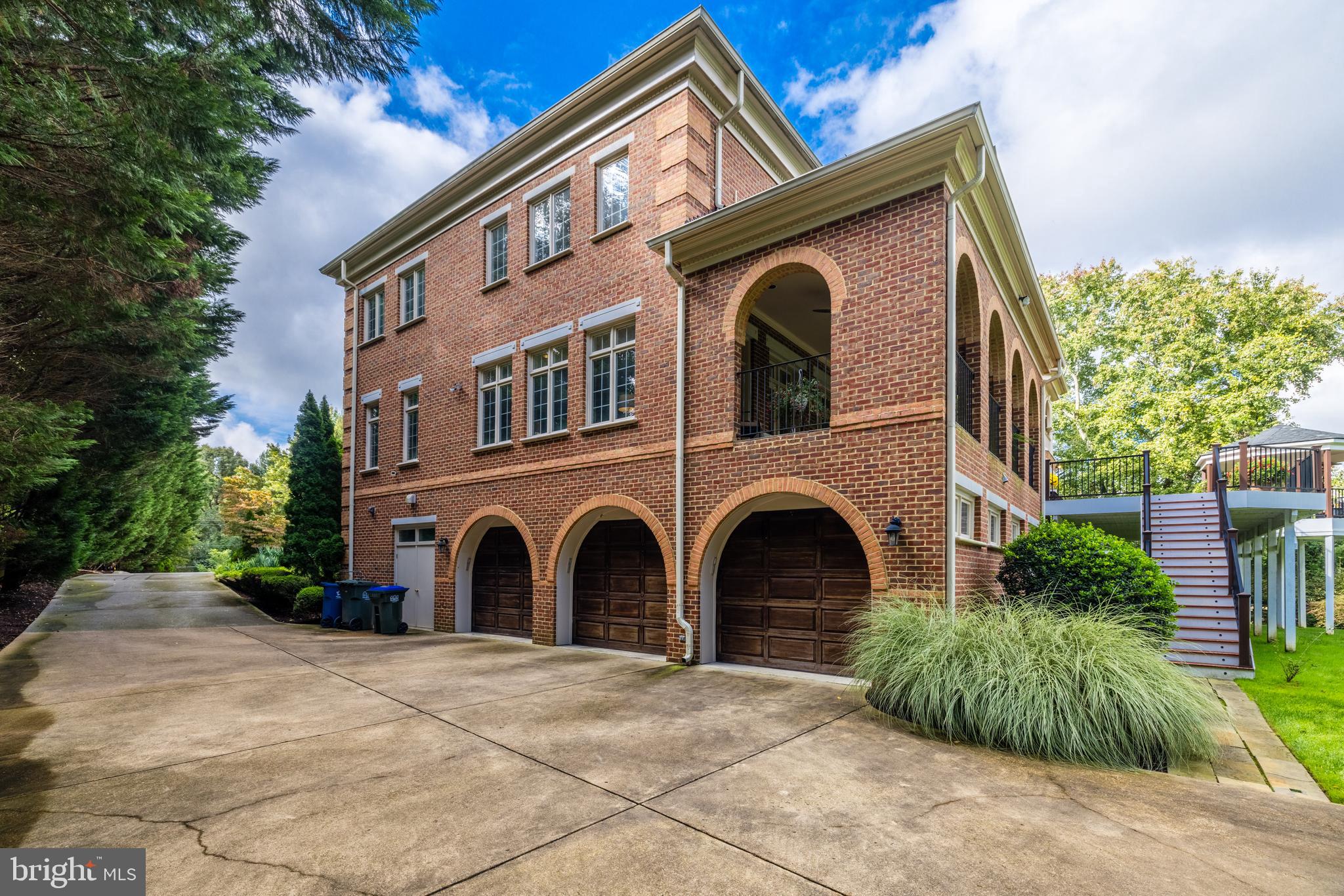 6832 Georgetown Pike McLean, VA 22101 - Photo 25 of 25 a front view of a house with a yard and garage