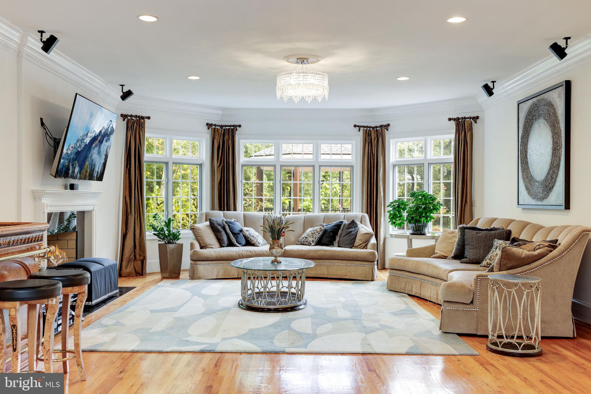 6832 Georgetown Pike McLean, VA 22101 - Photo 7 of 25 a living room with furniture large window and flat screen tv