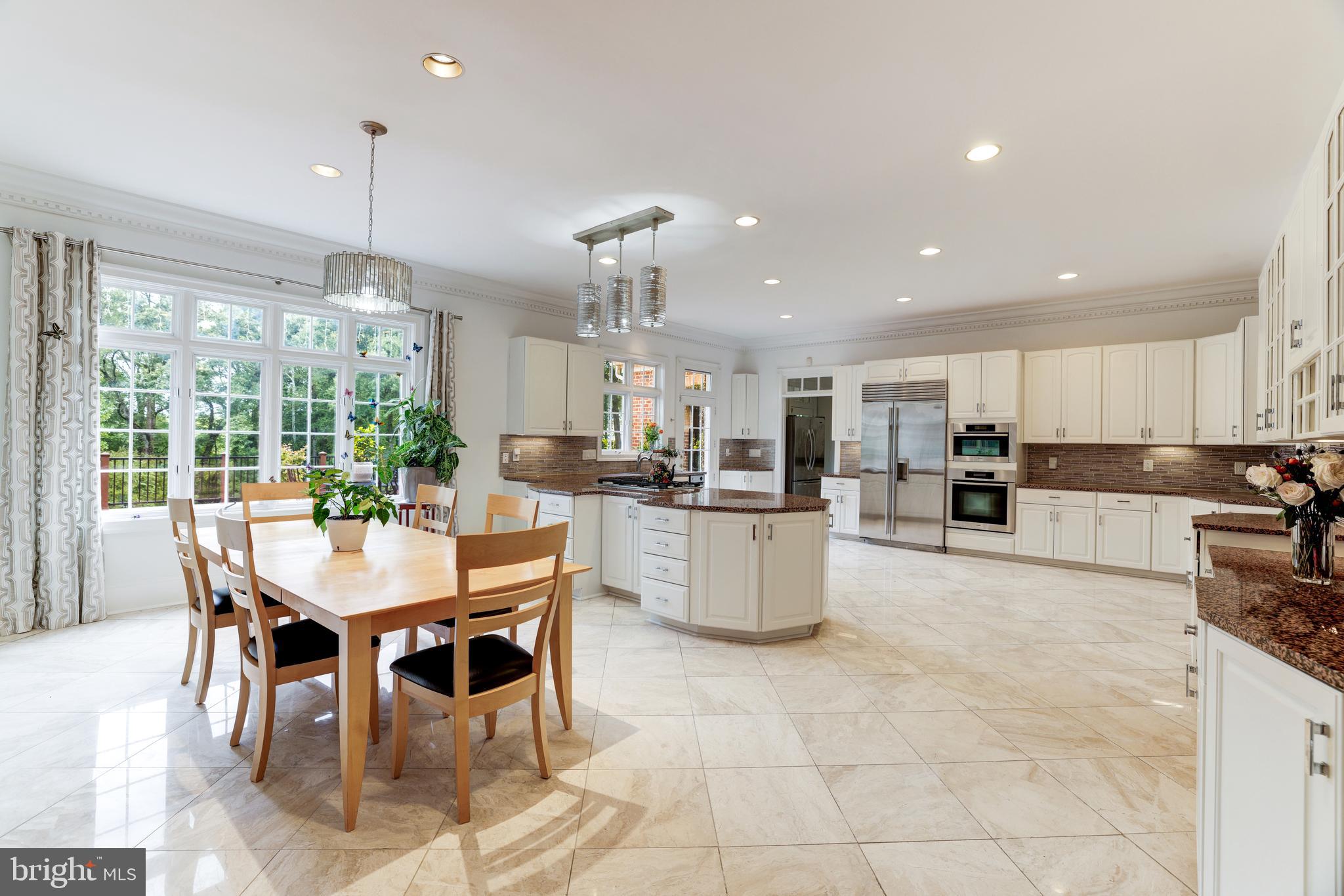 6832 Georgetown Pike McLean, VA 22101 - Photo 8 of 25 a kitchen with a dining table chairs and refrigerator