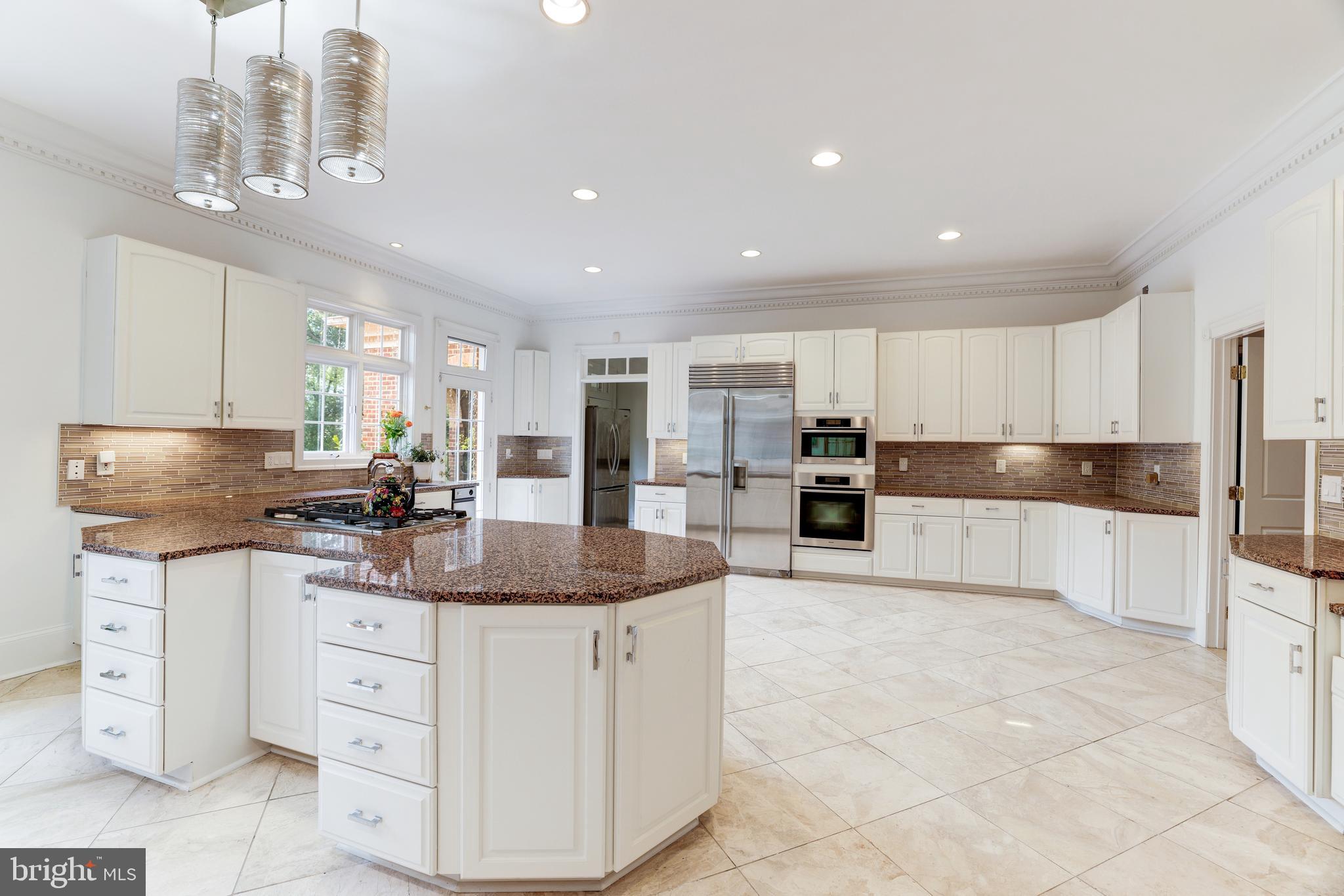6832 Georgetown Pike McLean, VA 22101 - Photo 9 of 25 a kitchen with stainless steel appliances granite countertop a sink and cabinets