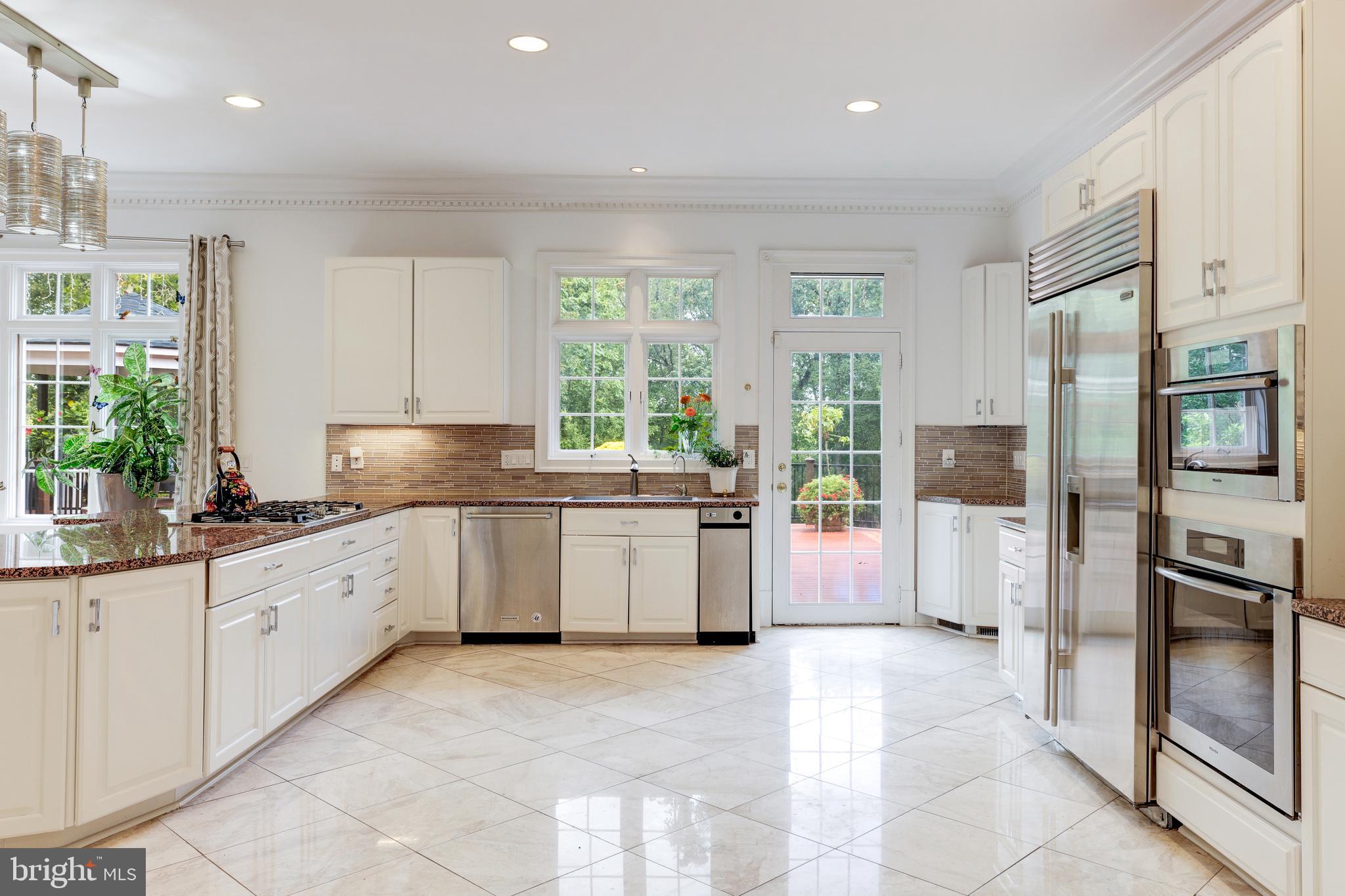6832 Georgetown Pike McLean, VA 22101 - Photo 10 of 25 a kitchen with a sink stove and refrigerator