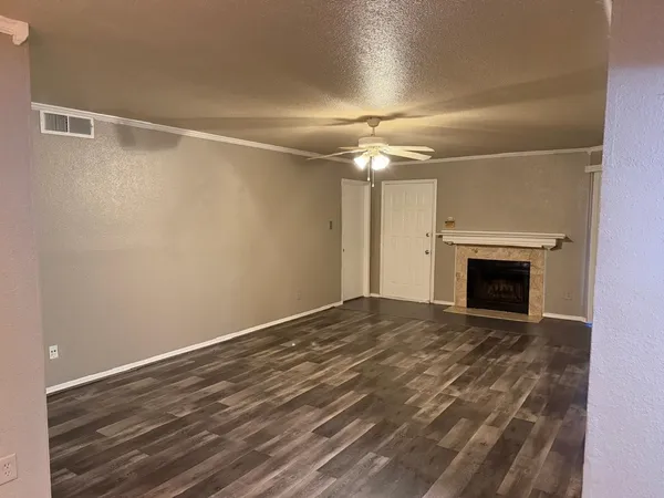 a view of empty room with fan and fireplace