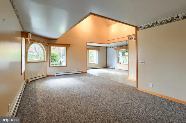 a view of a big room with closet and windows
