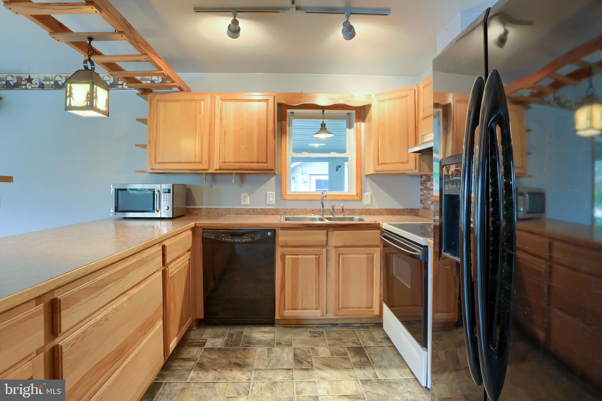 2130 Susquehanna Trail Liverpool, PA 17045 - Photo 32 of 54 a kitchen with stainless steel appliances granite countertop a refrigerator and a sink