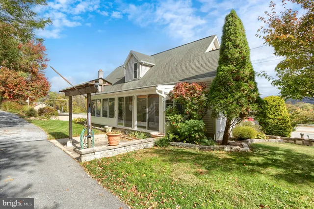 a front view of house with yard and green space