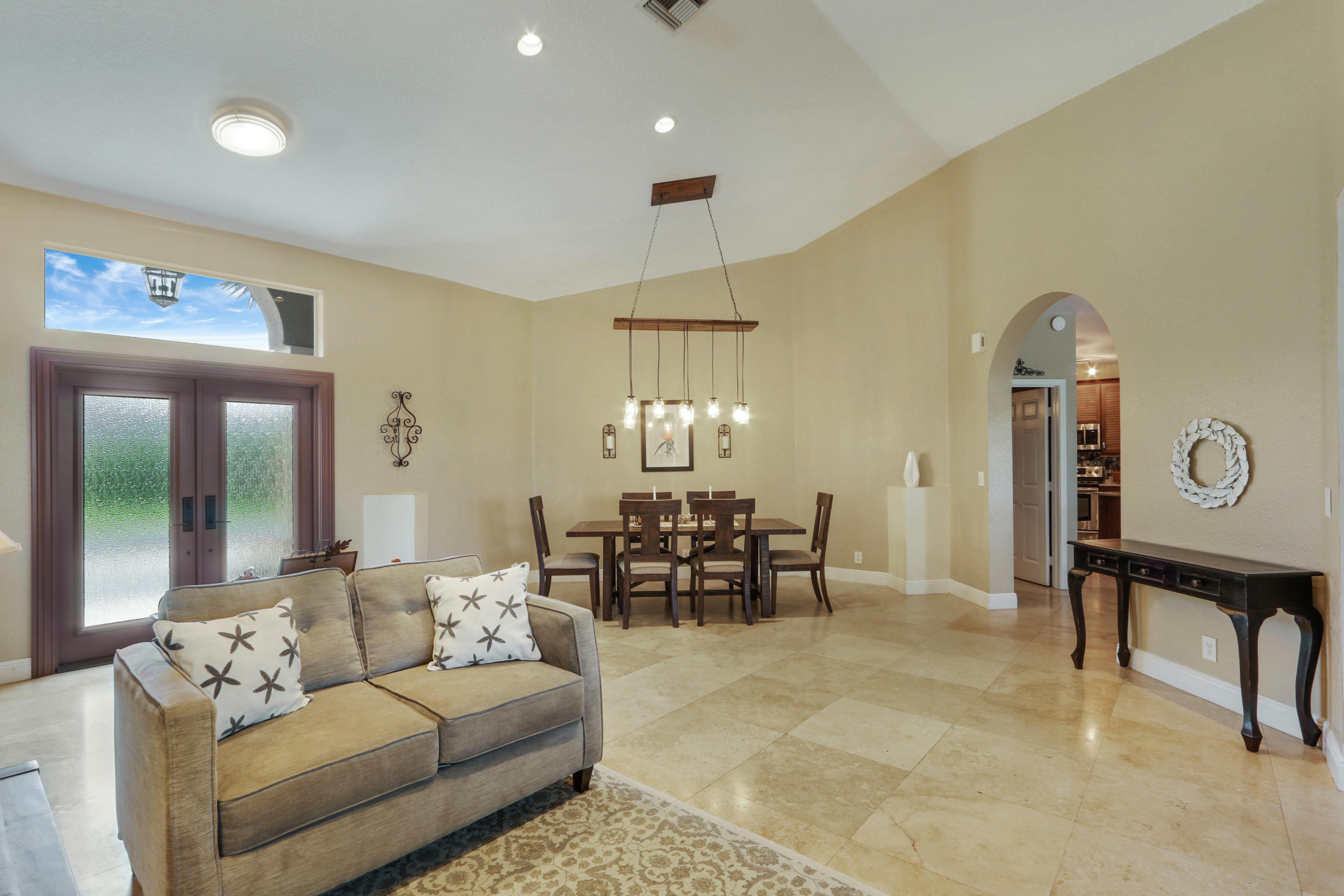 10951 Ravel Court Boca Raton, FL 33498 - Photo 4 of 26 a living room with furniture and a chandelier
