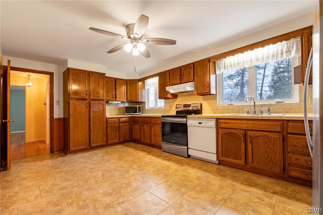 330 Wedgewood Road Bethlehem, PA 18017 - Photo 18 of 47 a kitchen with a refrigerator a sink and white cabinets