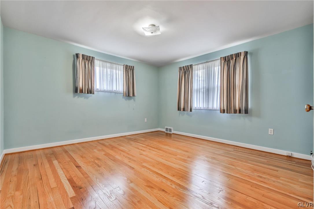 330 Wedgewood Road Bethlehem, PA 18017 - Photo 32 of 47 a view of an empty room with wooden floor and a window