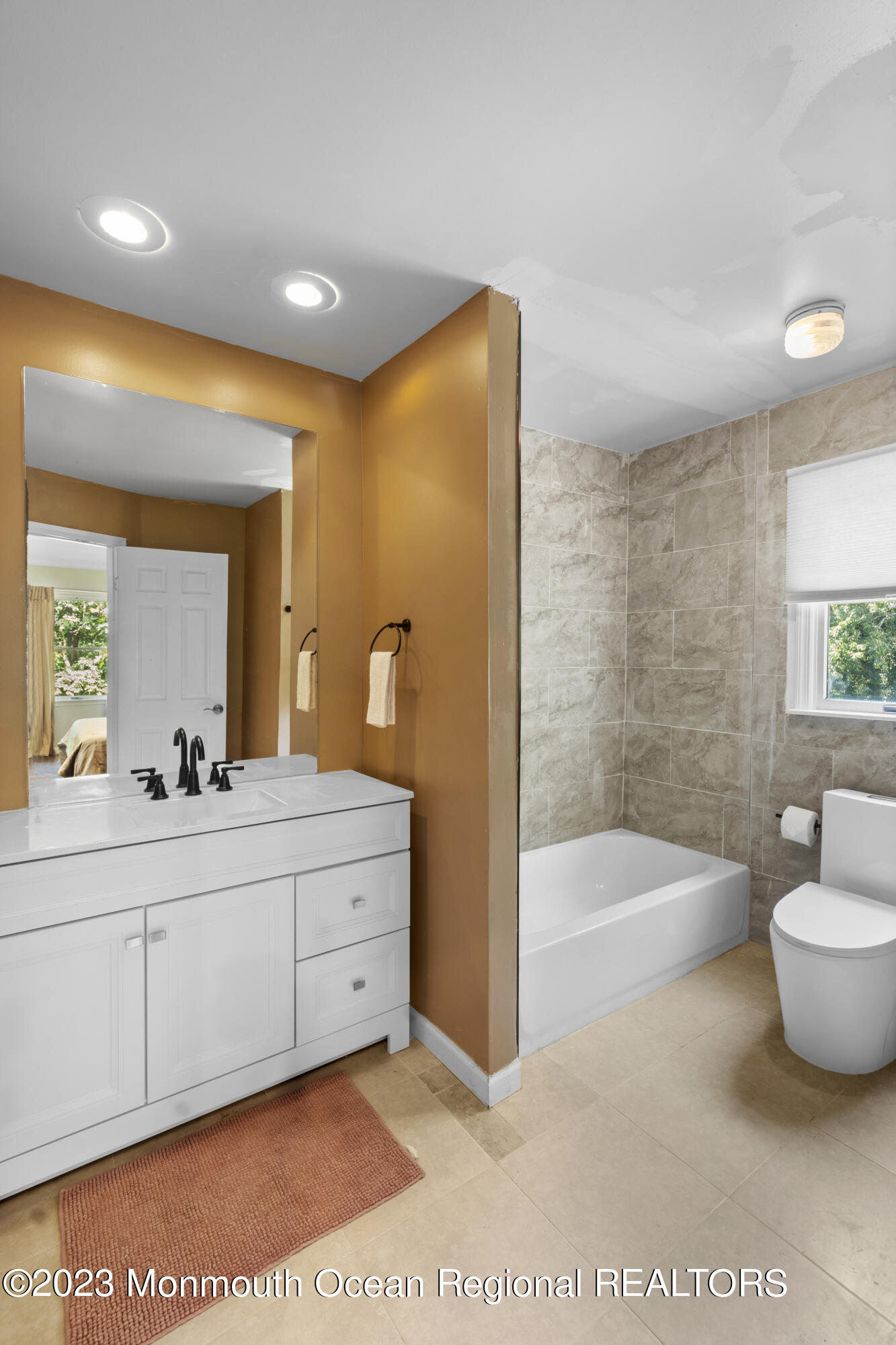 758 Anderson Road Jackson, NJ 08527 - Photo 23 of 35 a bathroom with a tub a sink and a large mirror