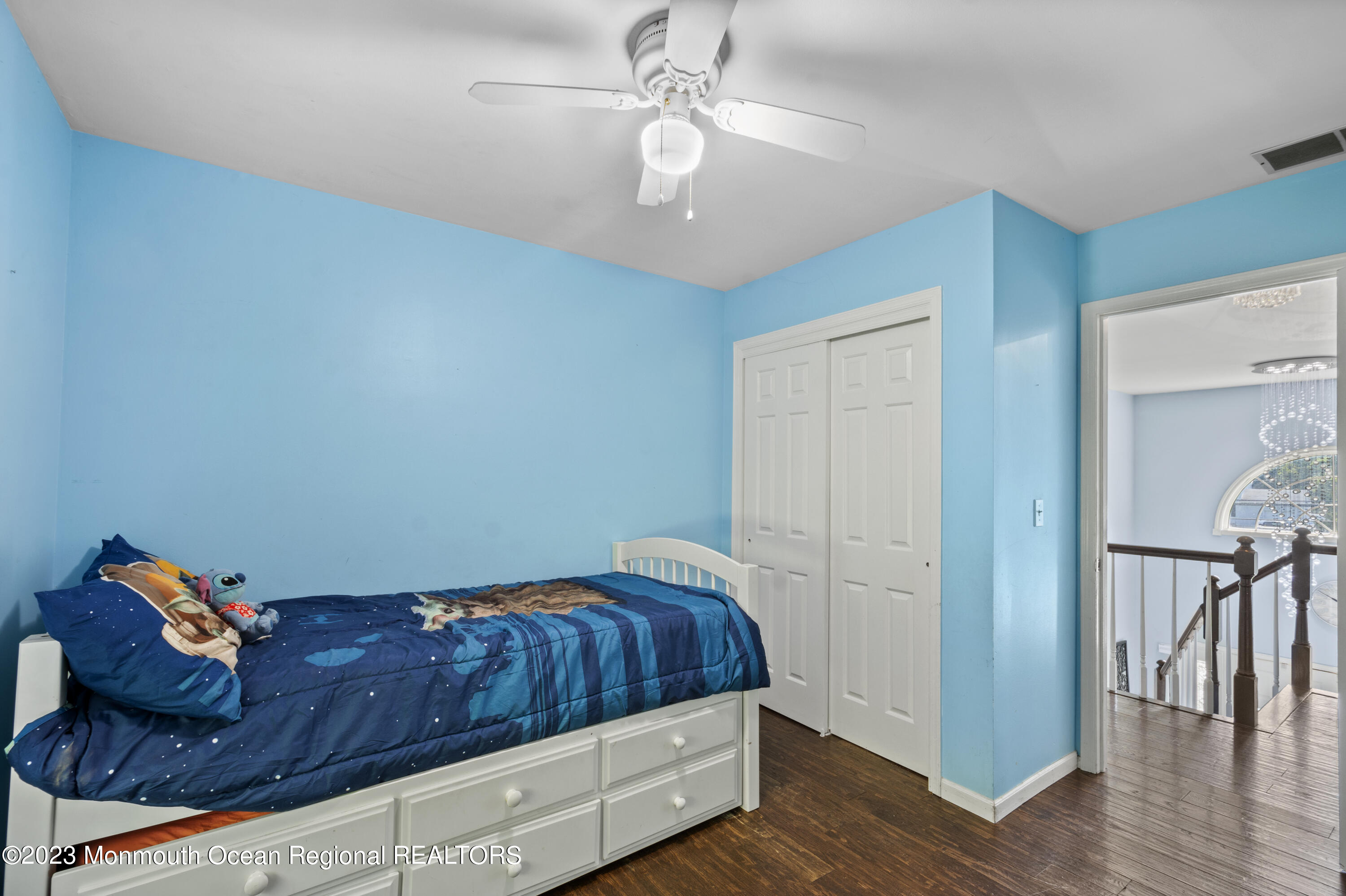 758 Anderson Road Jackson, NJ 08527 - Photo 26 of 35 a bedroom with a bed and a chandelier