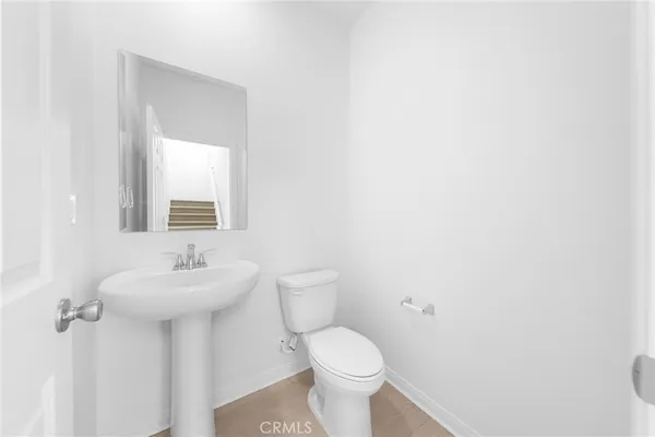 a bathroom with a sink mirror and toilet