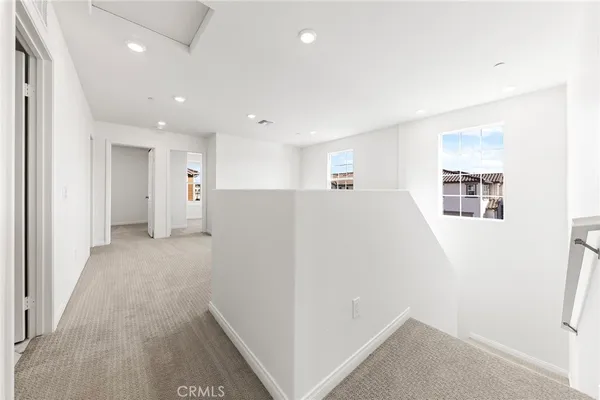 a view of a kitchen with refrigerator and windows