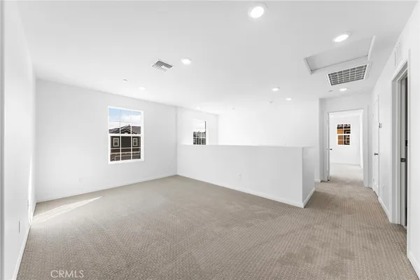 an empty room with windows and pillars in it