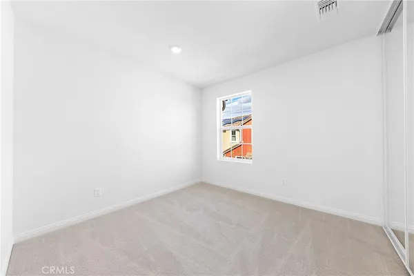 a view of an empty room and a window