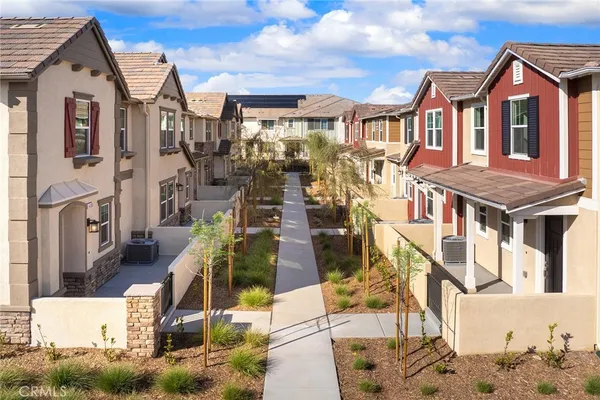 a front view of a residential apartment building with a yard