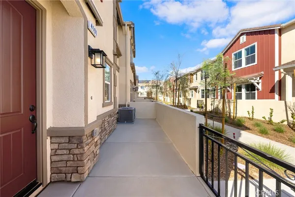 a view of a balcony and car parked