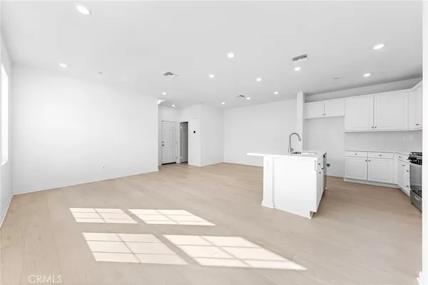 a view of a kitchen with a sink and a refrigerator