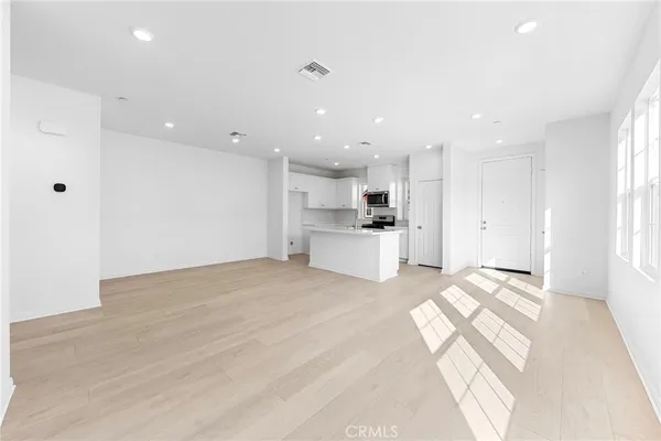 a view of kitchen with refrigerator and window