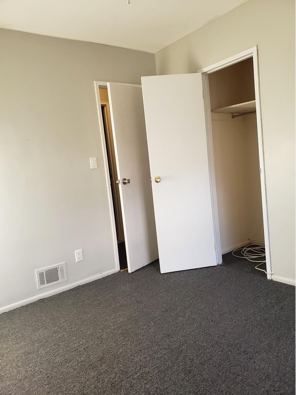 166-26 Gothic Drive, Unit 2 Queens, NY 11432 - Photo 9 of 10 Unfurnished bedroom featuring dark colored carpet, visible vents, and a closet