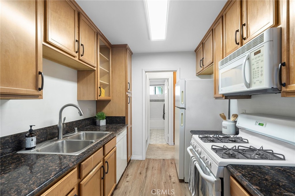 1450 West Lambert Road, Unit 358 La Habra, CA 90631 - Photo 12 of 31 a kitchen with stainless steel appliances granite countertop a sink stove and cabinets