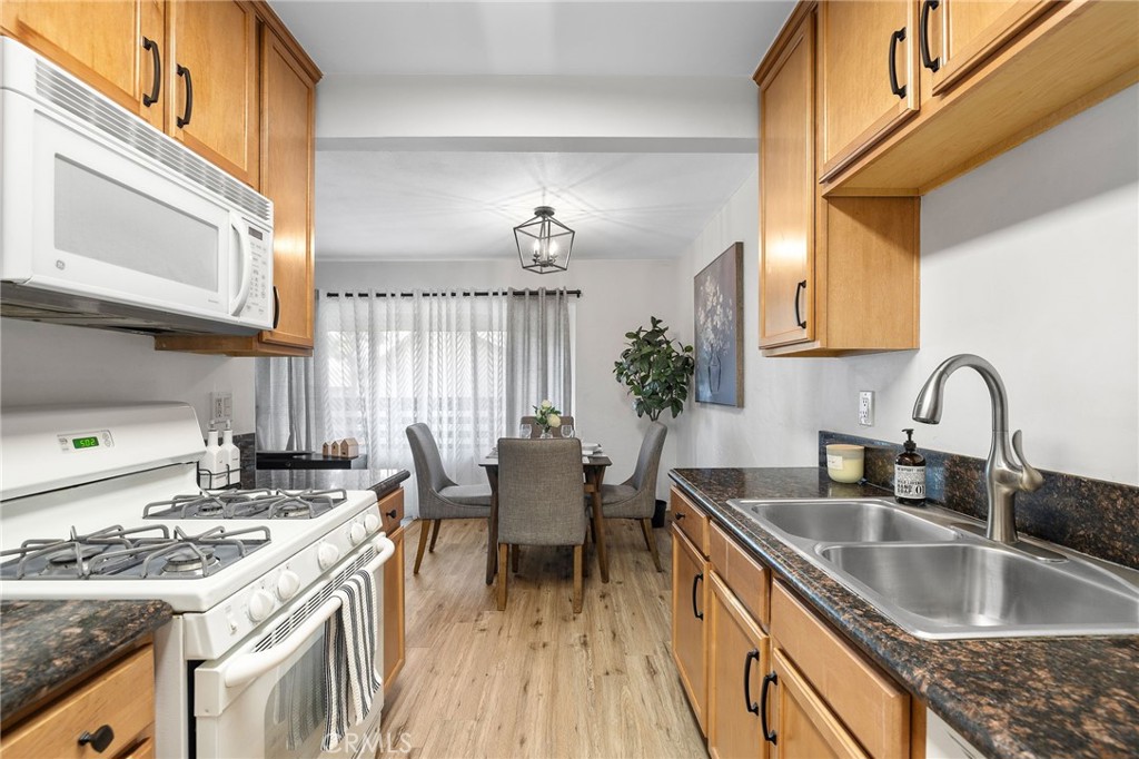1450 West Lambert Road, Unit 358 La Habra, CA 90631 - Photo 14 of 31 a kitchen with granite countertop a sink stove and cabinets
