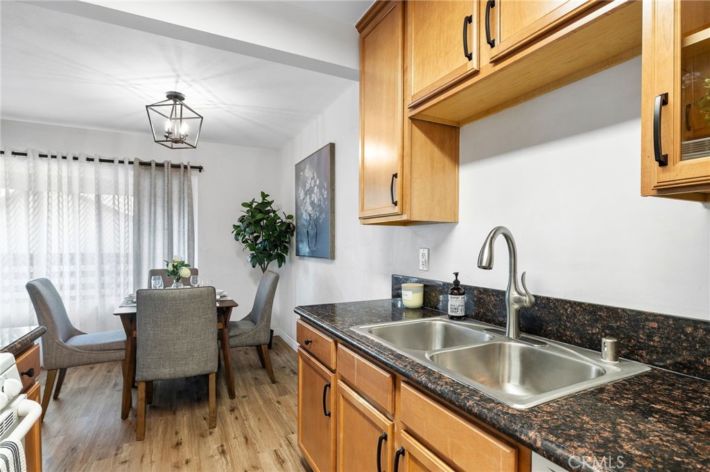 1450 West Lambert Road, Unit 358 La Habra, CA 90631 - Photo 15 of 31 a kitchen with granite countertop a sink and a stove top oven