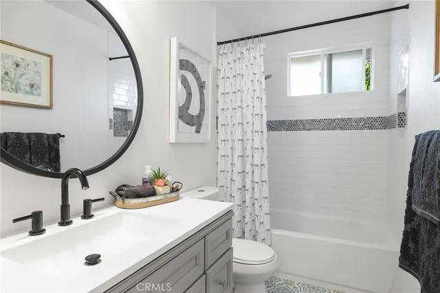 a bedroom with a large bed and a potted plant