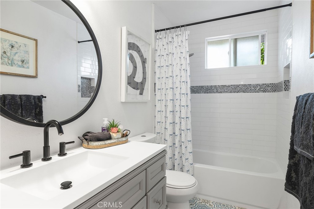 1450 West Lambert Road, Unit 358 La Habra, CA 90631 - Photo 17 of 31 a bathroom with a sink a toilet and a mirror