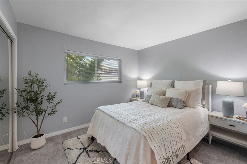 1450 West Lambert Road, Unit 358 La Habra, CA 90631 - Photo 18 of 31 a bedroom with a large bed and a potted plant
