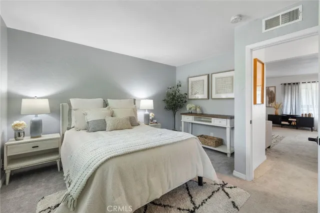 a bedroom with a bed and a large mirror