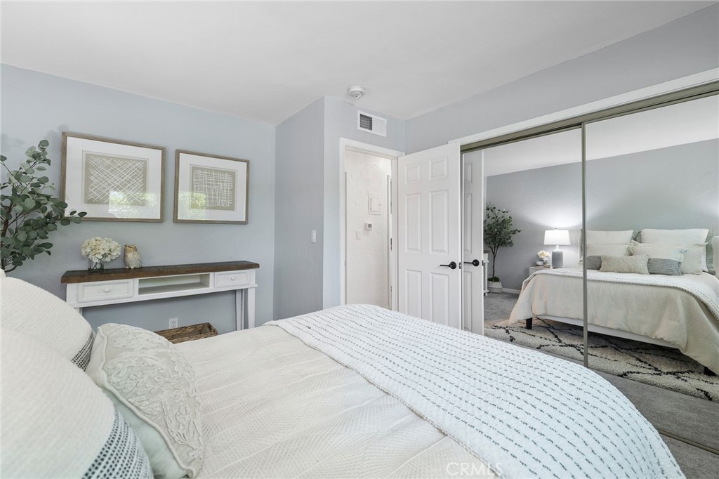 1450 West Lambert Road, Unit 358 La Habra, CA 90631 - Photo 20 of 31 a bedroom with a bed and a large mirror