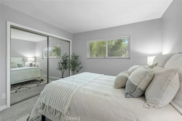 a view of a swimming pool with a lounge chair and palm trees
