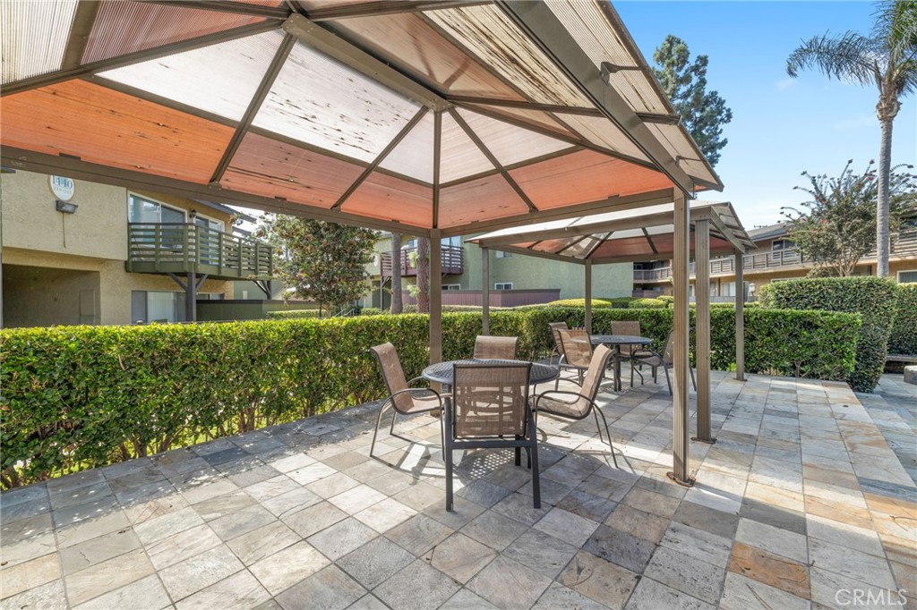 1450 West Lambert Road, Unit 358 La Habra, CA 90631 - Photo 26 of 31 a view of patio with a table and chairs under an umbrella