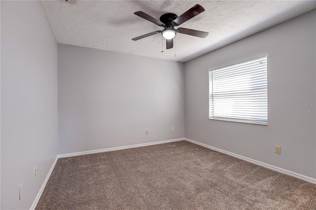1418 Buckner Road Valrico, FL 33596 - Photo 28 of 37 an empty room with a window and a fan