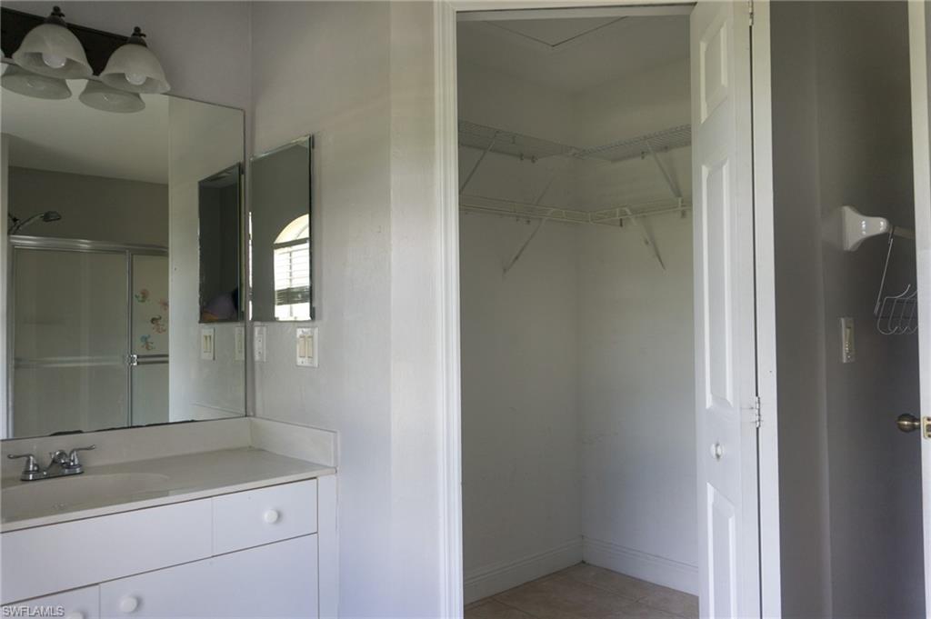 3703 Sunset Road Lehigh Acres, FL 33971 - Photo 8 of 12 a bathroom with a sink and a mirror
