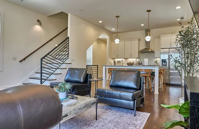 a living room with furniture and wooden floor