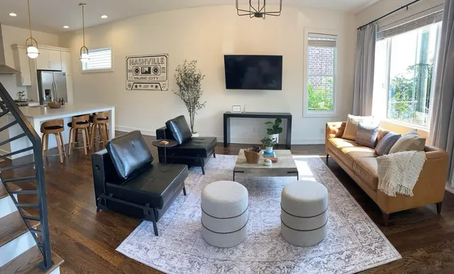 a living room with furniture a fireplace and a flat screen tv