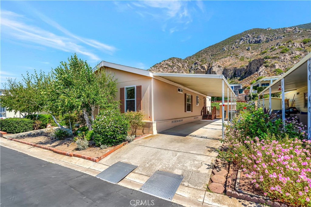 24 Gitana Avenue, Unit 164 Camarillo, CA 93012 - Photo 1 of 52 a front view of a house with a garden
