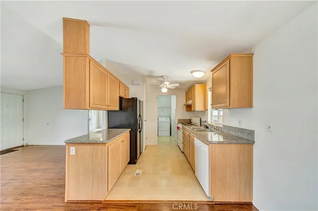 an empty room with a window and a ceiling fan