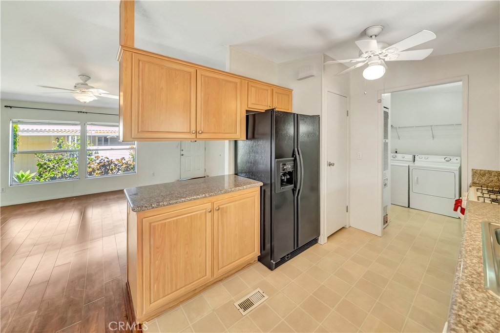 24 Gitana Avenue, Unit 164 Camarillo, CA 93012 - Photo 14 of 52 a kitchen with stainless steel appliances kitchen island granite countertop a refrigerator a stove and a sink with granite countertops