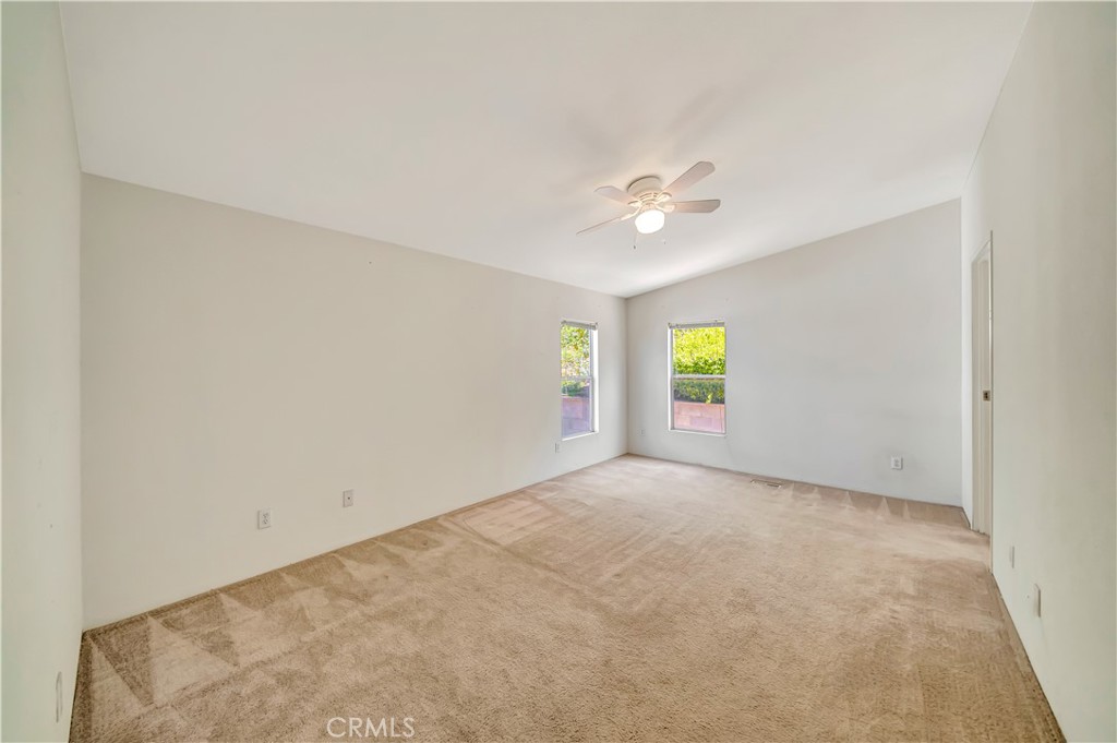 24 Gitana Avenue, Unit 164 Camarillo, CA 93012 - Photo 16 of 52 an empty room with windows and chandelier fan
