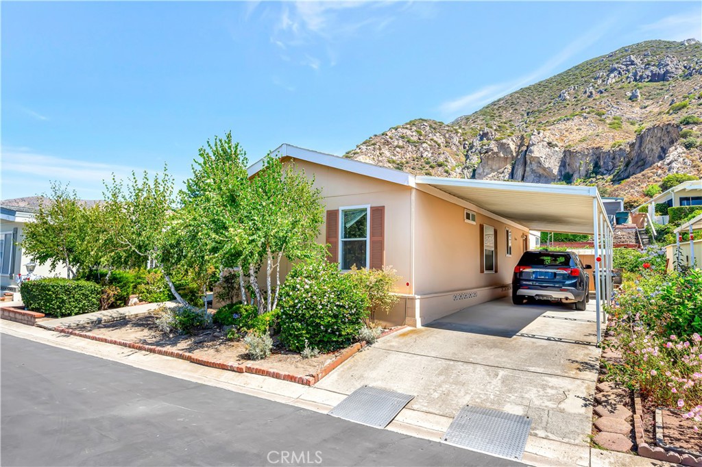 24 Gitana Avenue, Unit 164 Camarillo, CA 93012 - Photo 2 of 52 a front view of a house with a garden and plants