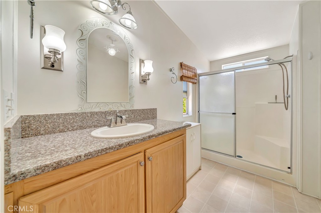 24 Gitana Avenue, Unit 164 Camarillo, CA 93012 - Photo 21 of 52 a bathroom with a granite countertop sink mirror and double