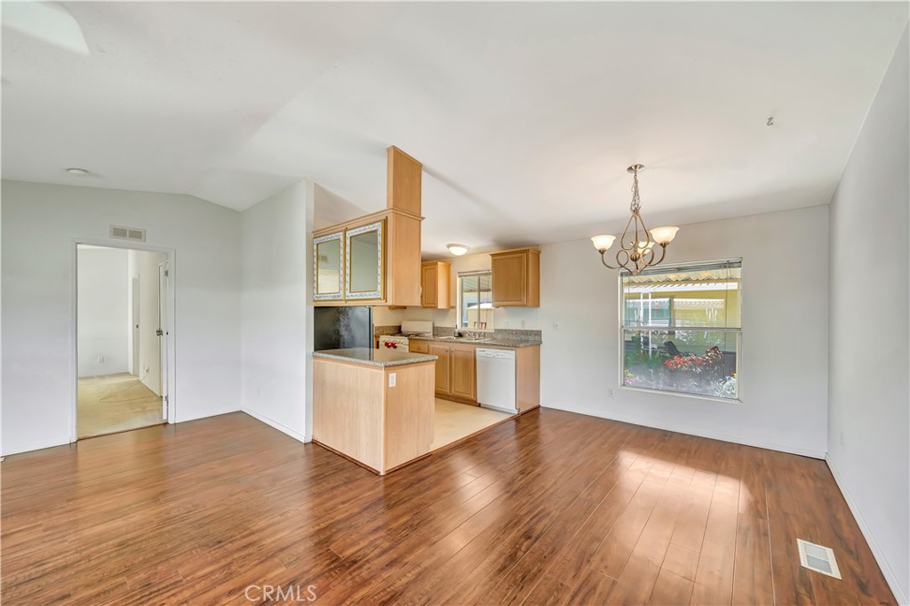 24 Gitana Avenue, Unit 164 Camarillo, CA 93012 - Photo 8 of 52 a large kitchen with cabinets wooden floor and stainless steel appliances