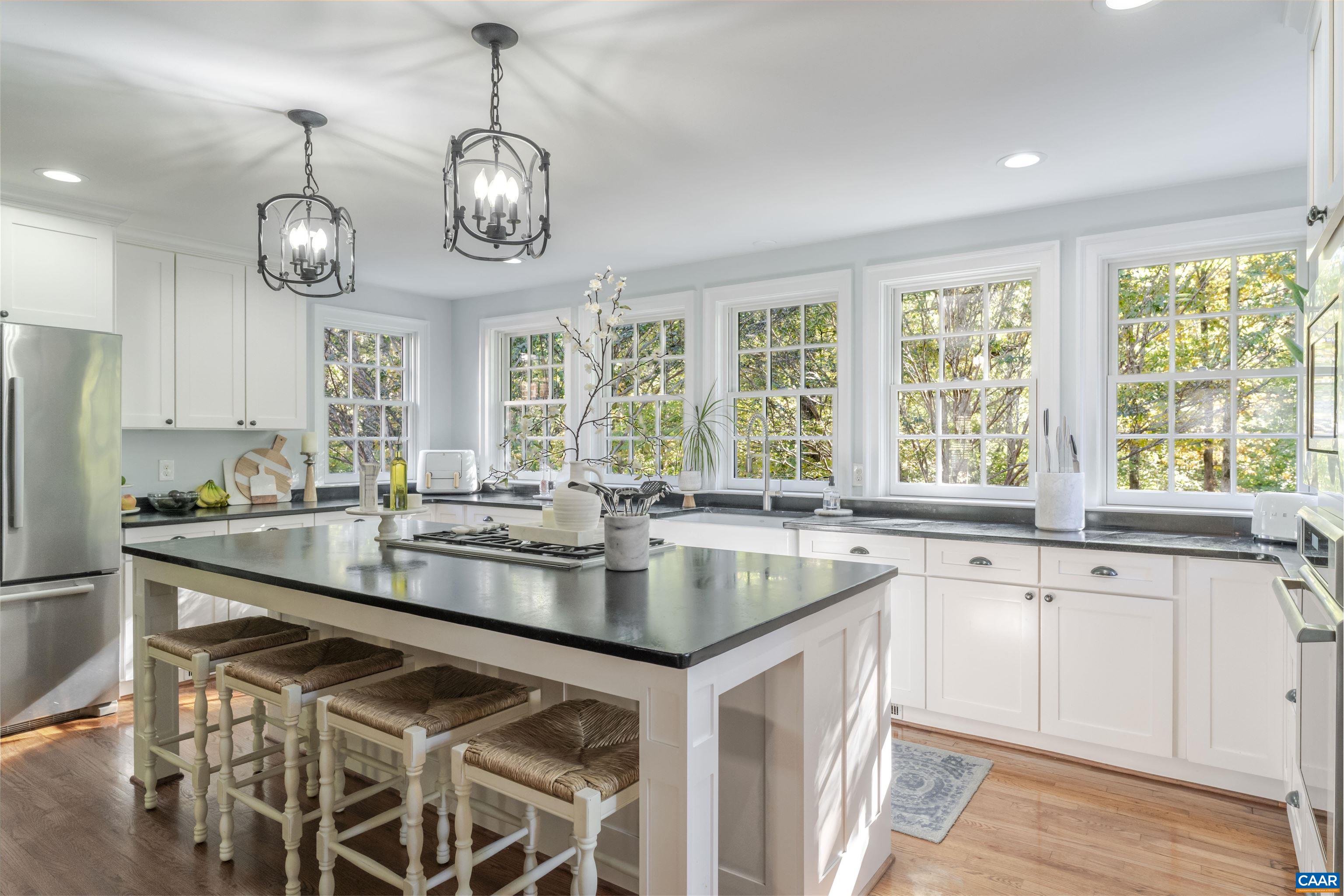 3359 Marsden Point Keswick, VA 22947 - Photo 11 of 47 a very nice looking kitchen with granite countertop a stove two sinks and cabinets