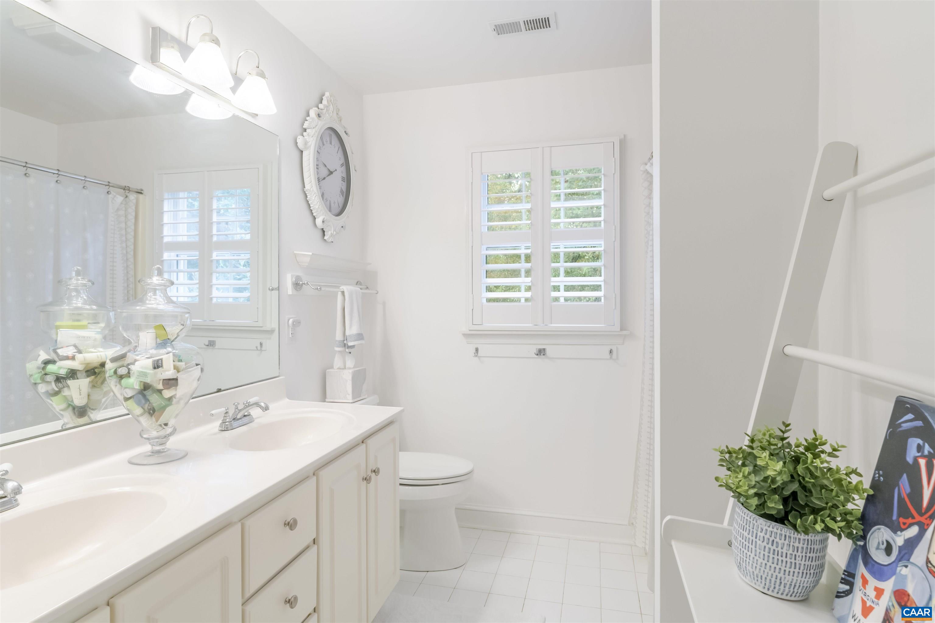 3359 Marsden Point Keswick, VA 22947 - Photo 44 of 47 a bathroom with a granite countertop sink a large mirror and a toilet