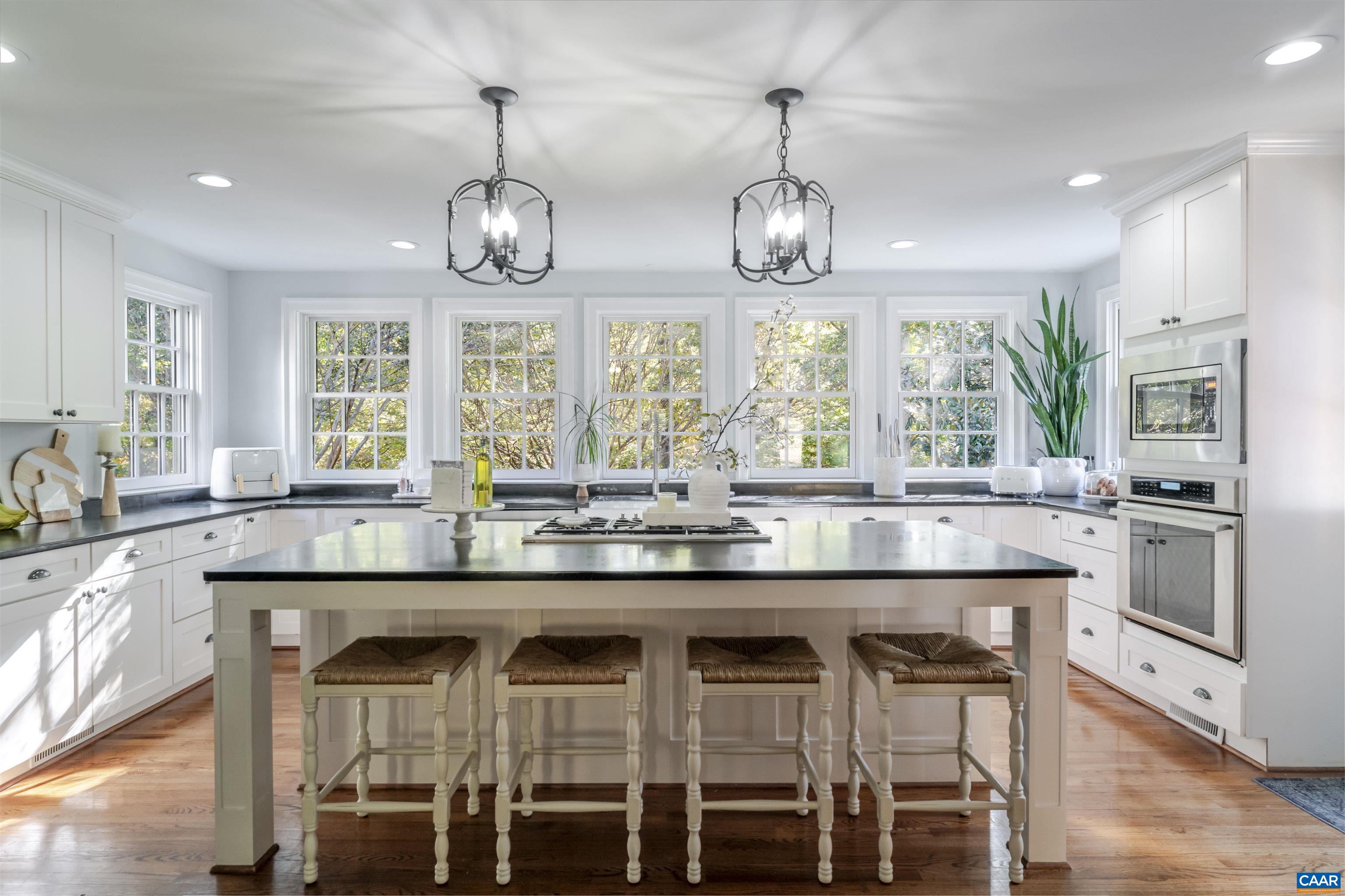 3359 Marsden Point Keswick, VA 22947 - Photo 10 of 47 a kitchen with stainless steel appliances granite countertop wooden floor and chairs