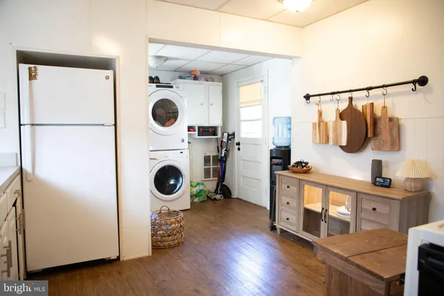 a kitchen with white cabinets and white appliances