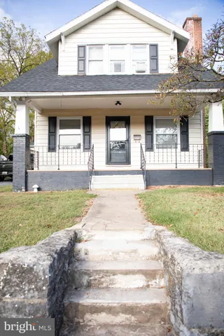front view of a brick house with a yard